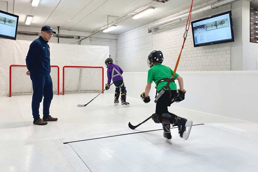 Player skating on a skatemill hockey treadmill